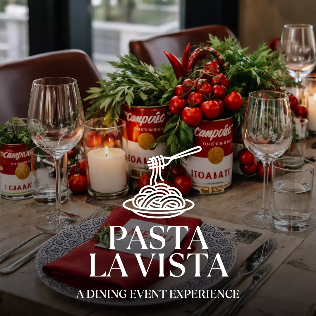 Decorated dining table with pasta theme and wine glasses at Motorworld Mallorca