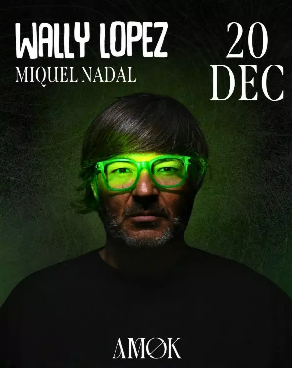 Portrait of DJ Wally López wearing green illuminated glasses.
