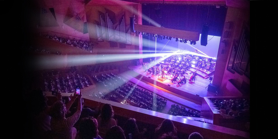 Interior view of Auditorium Palma during a concert with orchestra on stage and audience in the hall.