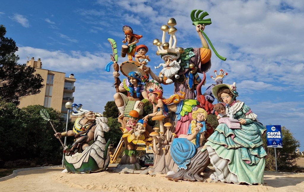 Large colorful Fallas sculpture with multiple characters displayed outdoors in El Toro