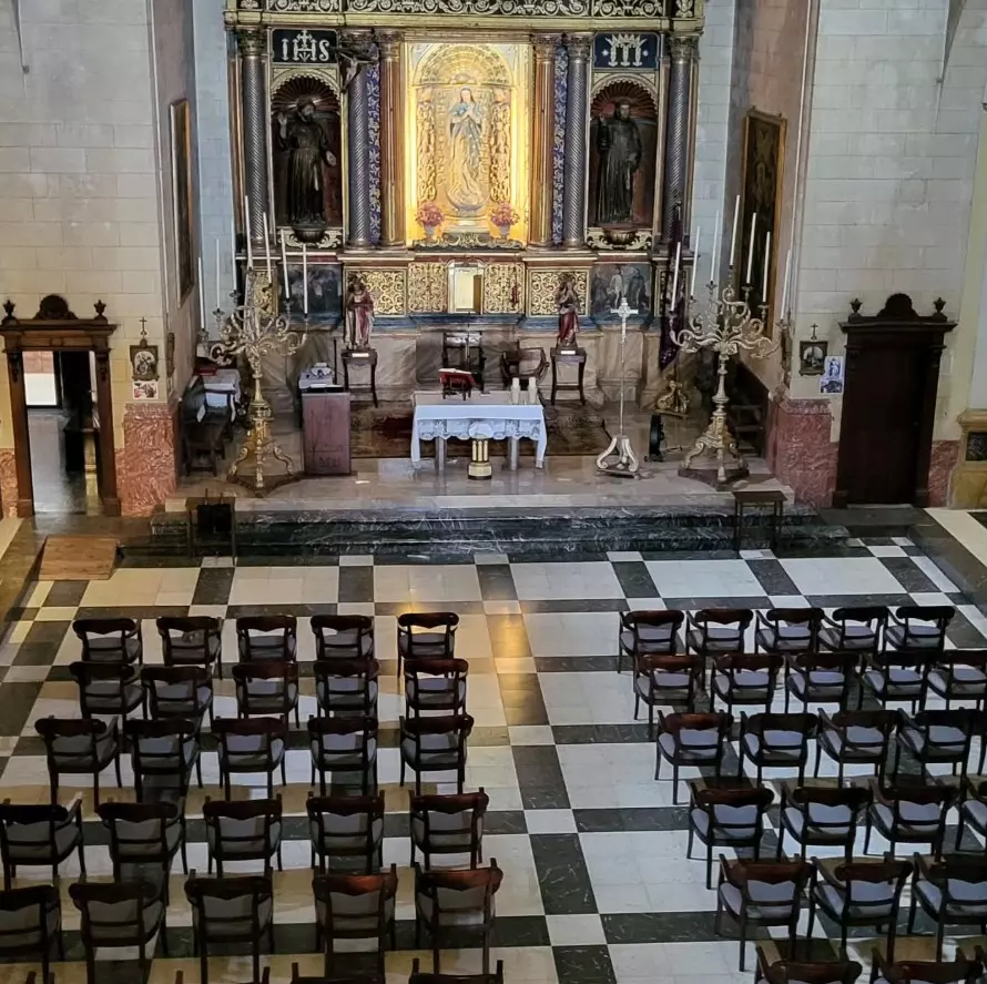 Alt text: Interior of the Artà Monastery prepared for a concert