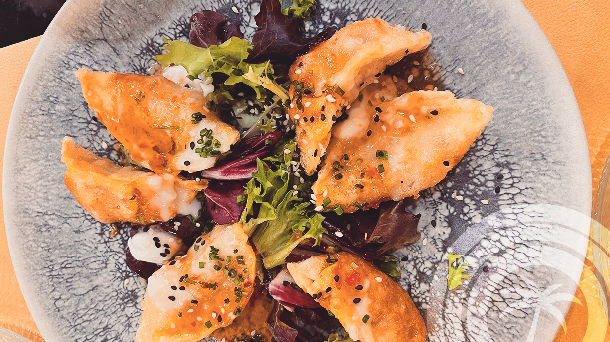 RoW w/c 24th November ÜBECK, MANACOR Food with flavours of the world, made from local produce, is on the menu at Übeck in Manacor. Chef Javier Hoebeeck – who moved from leading the Michelin-starred Fusion 19 to work at the Four Seasons Resort Mallorca in Formentor this year – opened his own Manacor gastro-tavern four years ago and has since expanded opening hours to seven days a week. Javier has also opened a second Übeck in Palma, following the success of the Manacor operation. From Wednesday to Sunday, Gabriel and Cassandra are at the helm of Übeck, with Cassandra wearing the chef’s hat. They’re a delightful, friendly couple who have been at Übeck since it opened, originally for five days a week. On their days off – Monday and Tuesday – two other members of the team take charge. Übeck offers what they call ‘real food’, made with care. Dishes are sensibly priced too. The restaurant is small, with table seating for around 24 diners, and a counter behind which is the bar and the food-plating area. The interior is contemporary, clean, and bright, with black and yellow as the main décor colours. The informal ambience is ideal for a lunch out or food with friends in the evening. Gabriel is a friendly and efficient host who speaks English and will explain any unfamiliar dishes or ingredients, and make recommendations from the short wine list. He’ll also describe any special dishes that day. Ossobuco was on the blackboard the night we were there. The menu is divided into starters, tacos, woks, meat, fish, and side dishes. We always have trouble choosing from the nine starters, as they’re all tempting. My personal favourites include the scallops with Thai curry sauce (14,50€), but for our latest visit, we chose the six chicken gyozas (11,25€) and Übeck’s unmissable croquetas – to which I am slightly addicted. (12,50€). They’re flavour bombs made from roast chicken, spinach, peanuts, and curry. For mains, my husband chose cod in tempura with a curry sauce, basmati rice, fried broccoli, and curry mayonnaise (16€), and I had a generous portion of squid with Korean basmati rice and vegetables (16,25€). The menu offers four desserts (priced 6€-7€). My husband chose ice cream with mini coulant, ‘Lotus’ cookie, and toffee, and I had a silky coconut-milk pannacotta draped with passion fruit coulis, with chocolate ganache and caramelized peanuts. Übeck’s wines are displayed on shelves marked with bottle prices, which seem fair. This is a place to try wine from Manacor, such as those from Vins Miquel Gelabert. Check out the special-edition vermouth too. We had wine by the glass at 5,50€ a glass. Eating at Übeck is a culinary journey through some of the world’s cuisines. We consider ourselves fortunate to live close to Manacor. Open every day. Lunch: 13:00h-16:00h & Dinner: 19:30h-23:00h Übeck Avinguda des Torrent, 23 07500 Manacor Mallorca Tel: 871 538 337 Email: info.ubeck@gmail.com NO WEBSITE Instagram: https://www.instagram.com/ubeck.mallorca/?hl=en Facebook: https://www.facebook.com/Ubeck.menjars