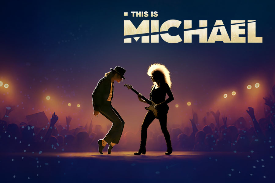 Stage scene from the show “This is Michael” with a performer dressed like Michael Jackson dancing beside a guitarist under bright concert lights.